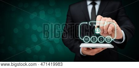 Businessman In Office Suit Holding Tablet And Pen. Written Virtual Text On Screen. Futuristic Image 