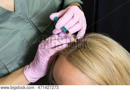 Trichologist, Beautician Doing Blond Woman Hair Mesotherapy Procedure. White Doctor Does Scalp Injec