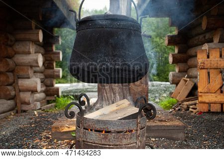 Black Cast Iron Boiler In The Capm, Cooking In Nature On Campfire