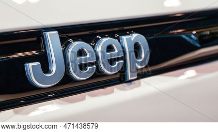 Metalic Jeep Car Brand Close Up View. Brand Of American Automobiles Produce Off-road Vehicles, Picku