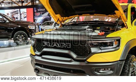 Close Up View Of Yellow Ram Truck Car On Display. Crowds Looking At New Car Models At Auto Show. Nat