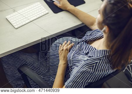 Pregnant Woman And Computer, Home Office And Pregnant Businesswoman. A Woman With A Huge Stomach Sit