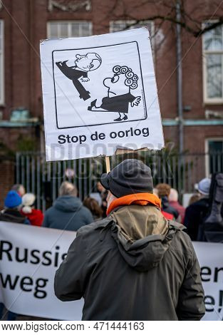 Amsterdam, The Netherlands, 24.02.2023, Person Holding Banner With Caricature Of Vladimir Putin And 