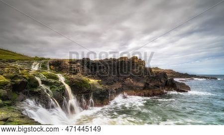 Dunseverick Falls With Small Cliffs And Streaks Of Water Falling Down To Atlantic Ocean, Causeway Co