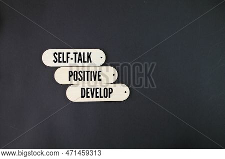 Wooden Board With The Words Develop Positive Self-talk. Business And Develop Positive Self-talk Conc