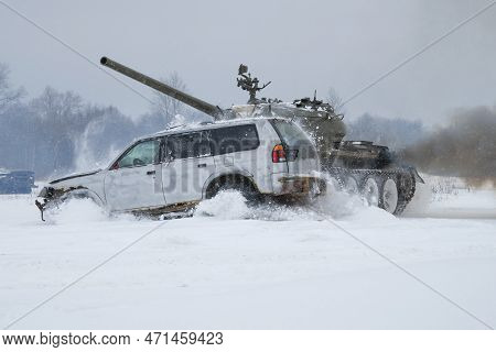 Krasnoye Selo, Russia - February 19, 2023: A Soviet Tank T-54 Rams A Old Passenger Car On A Snowy Fe