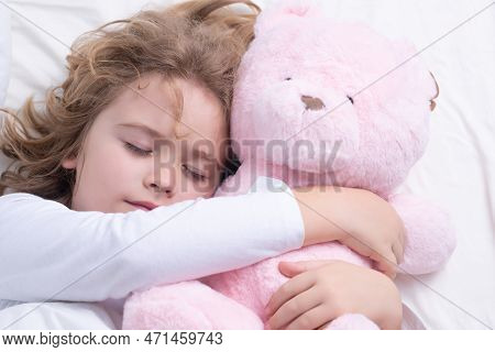 Sleep, Sleeping Concept. Little Boy Sleeping With A Toy Teddy Bear In Bed. Cute Kid Sleeping Well Al