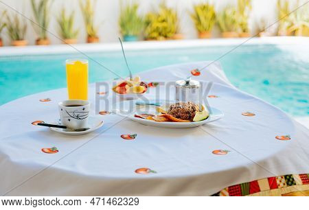Breakfast Served On The Table With A Swimming Pool In The Background. Fruit Salad. Traditional Break