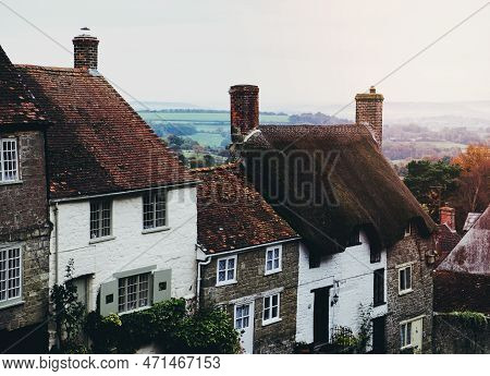 Village View Of Houses And Cottages With Chimneys And Thatched Roofs In Gold Hill.