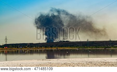 Fire Smoke Against The Backdrop Of The Kuyalnitsky Estuary In The Evening Before Sunset
