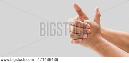 A Man Cracking Their Knuckles, On A Gray Background.