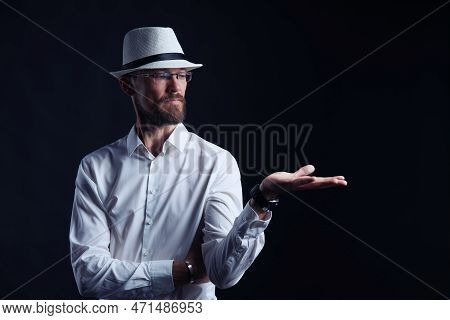 Serious Middle Age Man In White Shirt And Hat Showing Blank Copy Space On His Palm