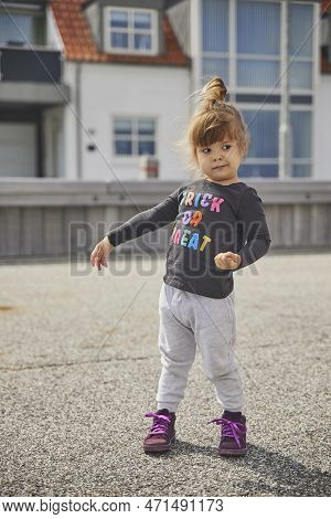 Stylish Child Playing In The Town In Denmark