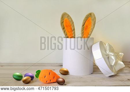 Easter Eggs And A White Basket With Rabbit Ears