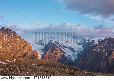 Vivid Alpine Landscape With High Snow Mountains And Large Glacier In Sunrise Colors. Colorful Mounta