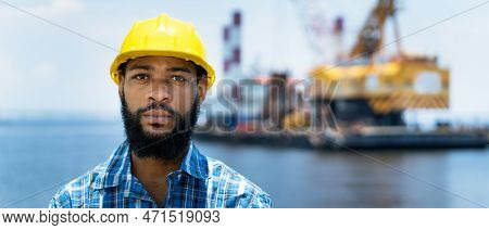 Portrait Of Offshore Worker With Digger And Plattform And Ship At Blue Ocean