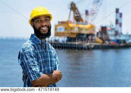 Black Offshore Worker With Digger And Plattform And Ship At Blue Ocean