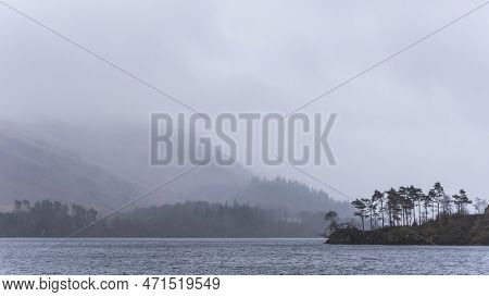 Beautiful Calm Peaceful Winter Landscape Over Thirlmere In Lake District With Fog And Layers Of Tree