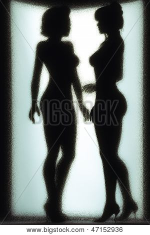 silhouette of two nude girls