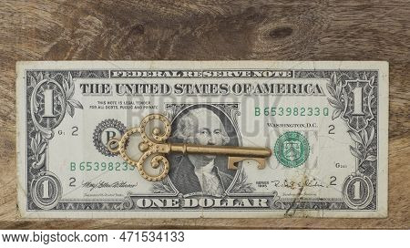 Dollar Bill With Old Vintage Key. Money Opens Many Doors. Ancient Key On Banknotes