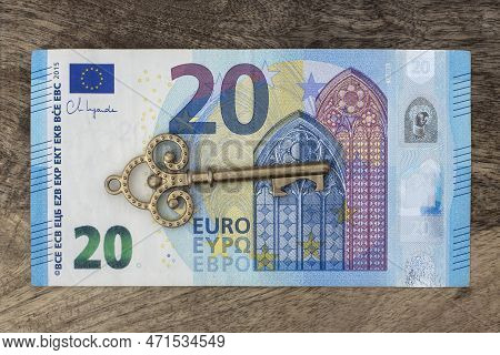 Twenty Euro Banknote With Old Vintage Key. Money Opens Many Doors. Ancient Key On Banknotes