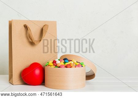 Shopping Bag With Gift Box On Colored Background Perspecrive View. Space For Text Holiday Concept.