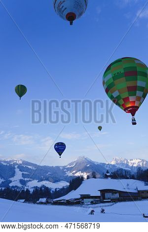 Balloons Hanging In The Air Over Swiss Alps. Taken At 42nd International Balloon Festival In Chateau