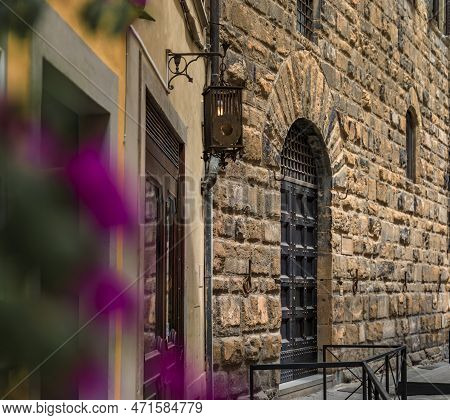 Gothic Buildings And Flowers On An Old Street In Centro Storico, Florence, Italy