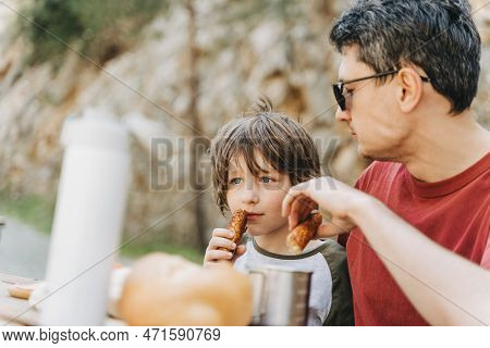 Close-up View Of Father Hugs His School Boy Son On A Family Picnic In The Mountains. Child Kid And H