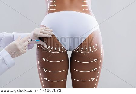 Young Slim Black Woman In White Bikini With Abstract Lines Gets Injection From Beautician In Hips