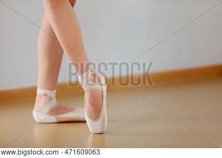Cropped Image Of Female Legs Standing On Pointe In Ballet Studio School Indoors. Classic Ballet Perf