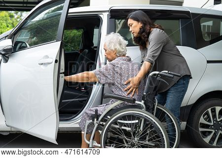 Caregiver Help And Support Asian Elderly Woman Sitting On Wheelchair Prepare Get To Her Car To Trave