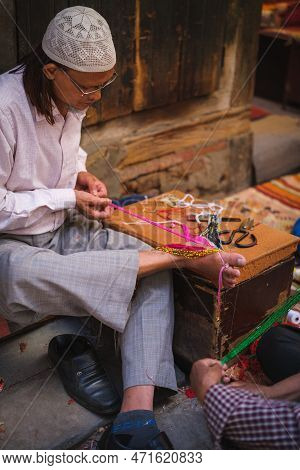 Kathmandu, Nepal, 04 23 2022: Webster Knitting Cloth With His Feet