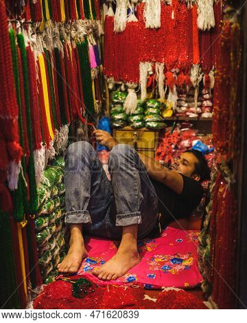 Kathmandu, Nepal, 04 23 2022: A Webster Lying In His Booth In Kathmandu