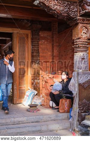 Kathmandu, Nepal, 04 23 2022: A Girl Taking A Break In Kathmandu Bazaar During The Pandemic, Wearing