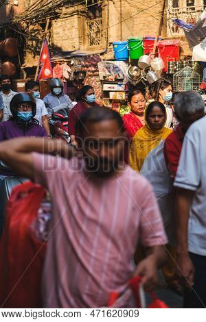 Kathmandu, Nepal, 04 23 2022: A Woman Deep In The Crowd In Kathmandu Bazaar