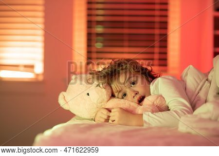 Scared Boy In Bed. Kid In Bed With Toy Teddy Bear. Nightmare For Children. Nap And Sleep Time. Beddi