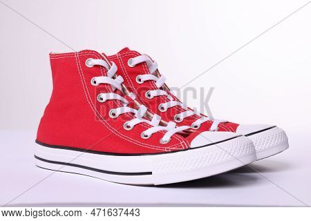Pair Of New Red Stylish High Top Plimsolls On White Background