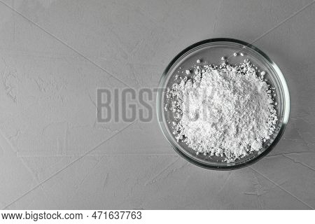 Petri Dish With Calcium Carbonate Powder On Grey Table, Top View. Space For Text