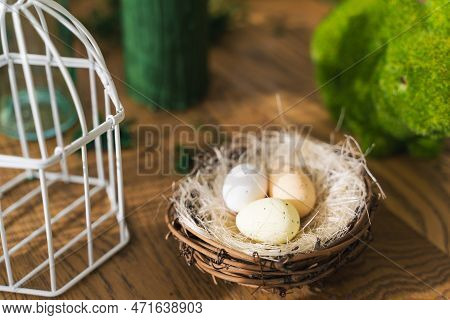 On A Wooden Table In A Decorated Nest Are Three Easter Eggseaster, Spring, Eggs, Holiday, Green. Eas