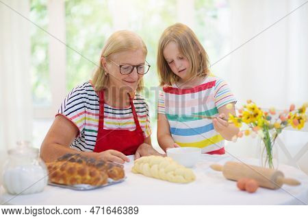 Mom And Child Baking Bread. Grandmother And Little Girl Bake Challah, Traditional Jewish Bread For S