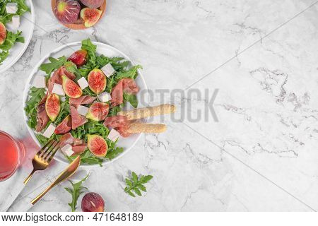 Autumn Figs Salad With Arugula, Feta, Raw Ham In Two White Plate On Light Marlbe Background Served W