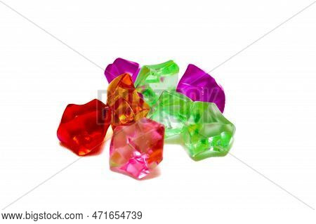 Beautiful Plastic Gems Of Different Colors On A White Isolated Background. Artificial Multi-colored 
