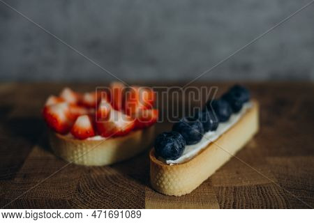 Beautiful Young Chef Decorating Delicious Dessert On Modern Kittchen