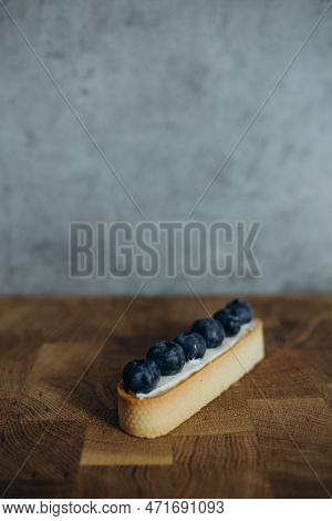 Beautiful Young Chef Decorating Delicious Dessert On Modern Kittchen