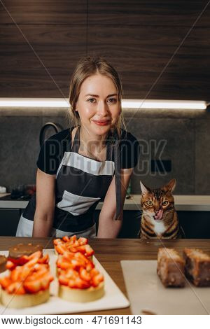 Funny Bengal Cat In The Kitchen Dressed As A Cook.