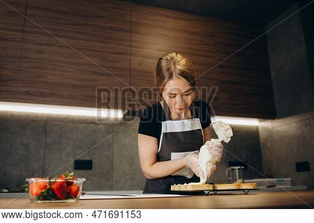 Pastry Chef Decorates The Cake With Berries