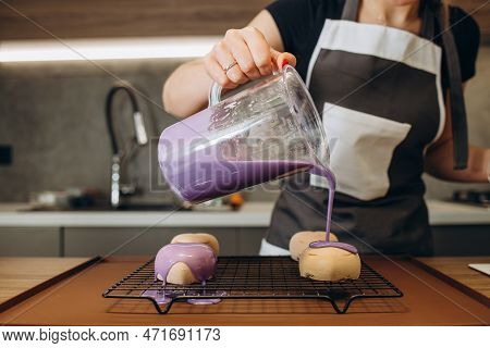 Close Up Of Professional Confectioner Hands Spooning The Warm Chocolate Glaze Unevenly Over The Prof