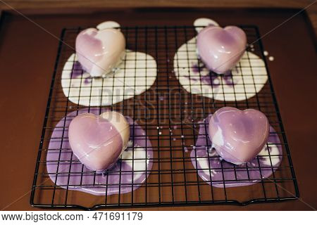 Close Up Of Professional Confectioner Hands Spooning The Warm Chocolate Glaze Unevenly Over The Prof