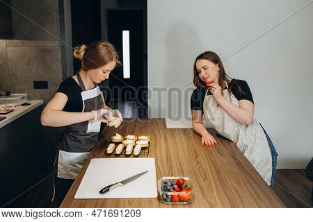 Beautiful Young Chef Decorating Delicious Dessert In Modern Kittchen